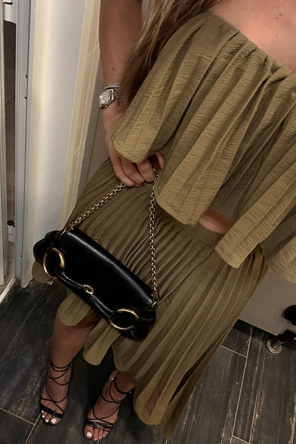 Olive pleated strapless crop top styled with matching midi skirt, black bag and lace-up heels.
