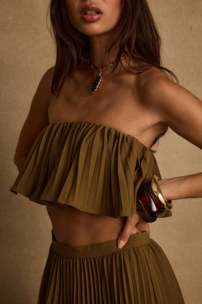 Lifestyle shot of the olive crop top styled for day-to-night versatility.
