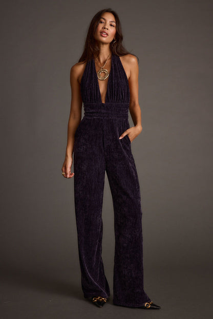 Back view of the velvet jumpsuit showing the silhouette and fit.