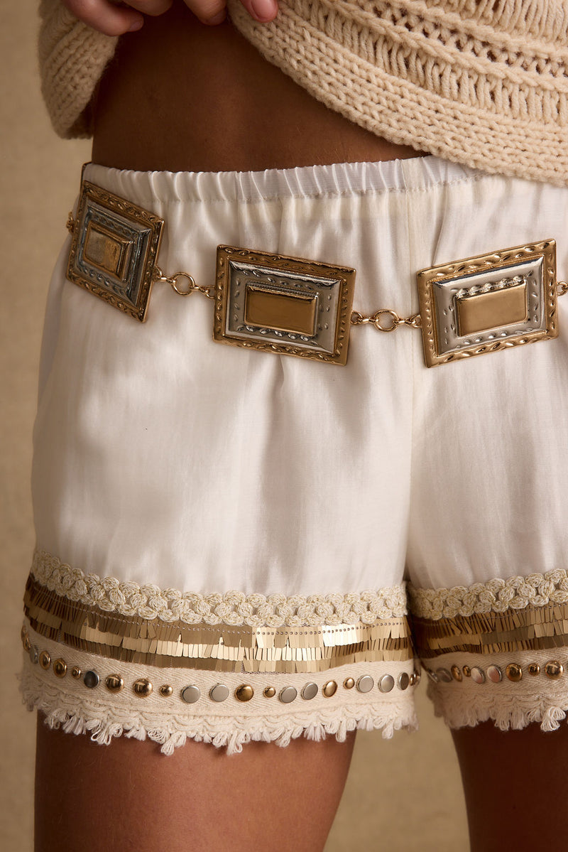 Gold belt with refined detailing and a flattering silhouette.