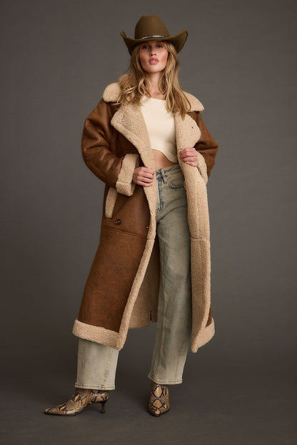 Brown jacket with refined detailing and a flattering silhouette.