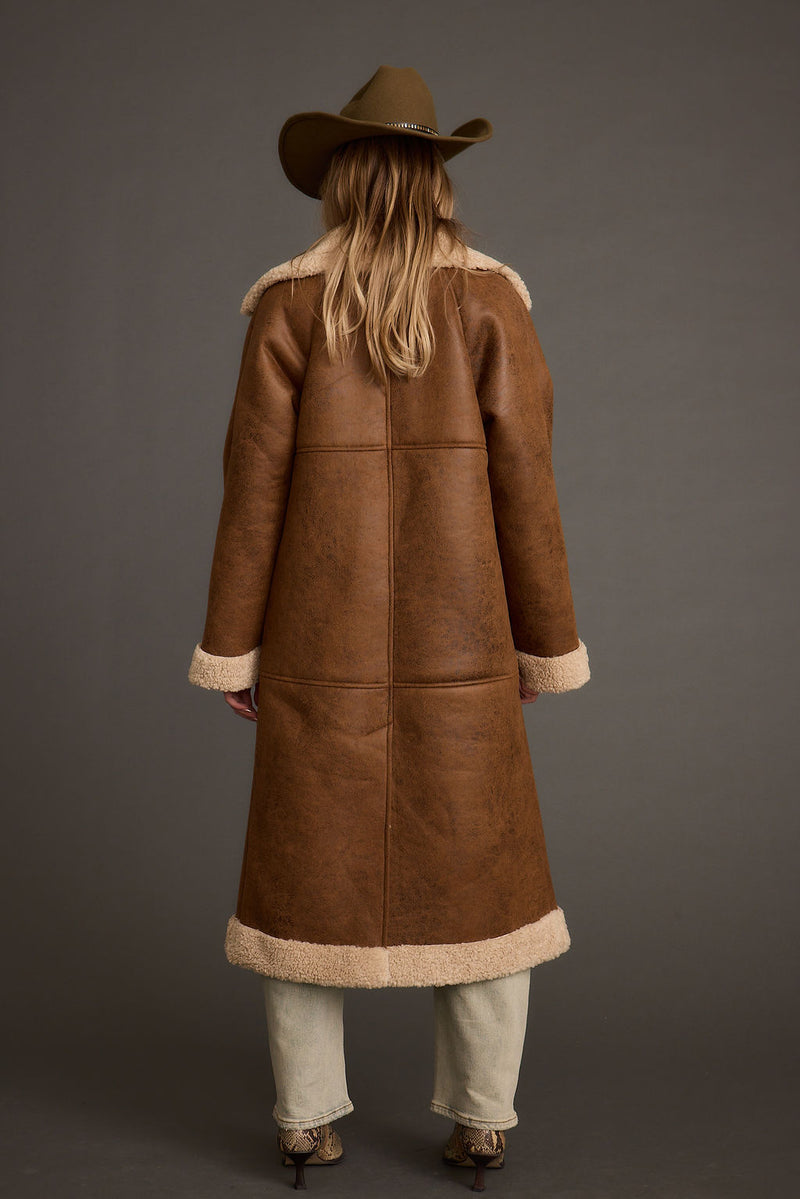 Back view of the brown jacket showing the silhouette and fit.