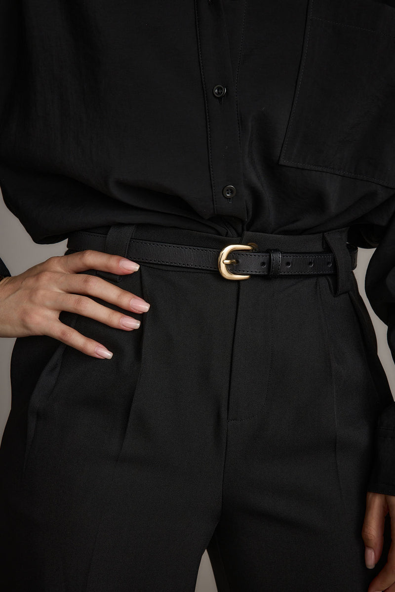 Close-up of the Liya Gold Genuine Leather Skinny Belt showcasing the leather texture and craftsmanship.