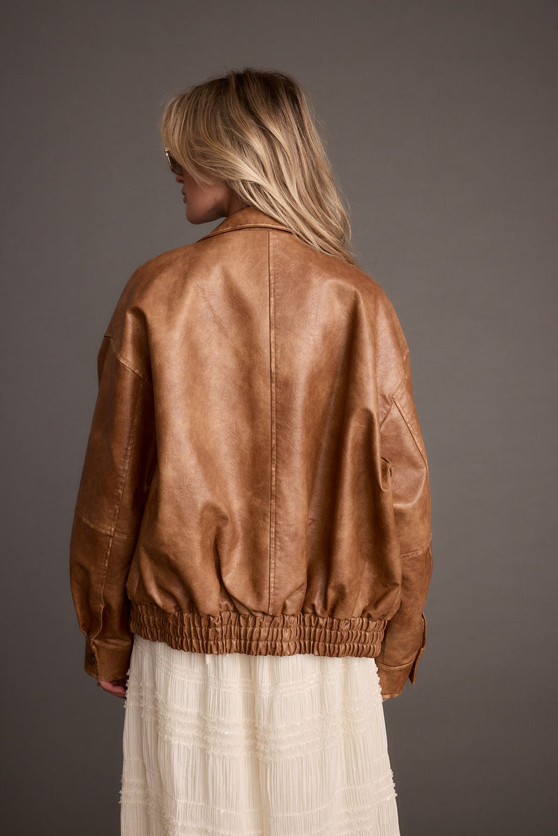 Close-up of the London Calling Cognac Oversized Faux Leather Jacket showcasing the faux leather texture and craftsmanship.