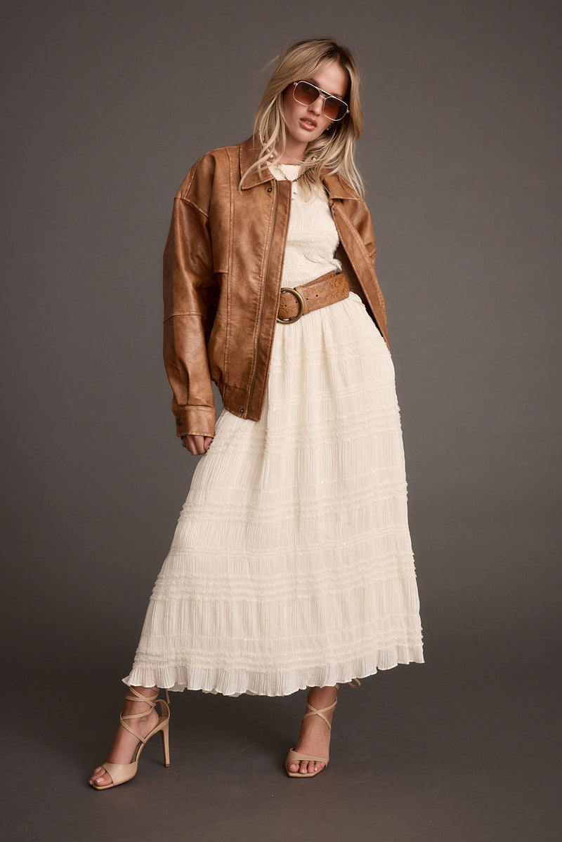 Lifestyle shot of the cognac jacket styled for day-to-night versatility.
