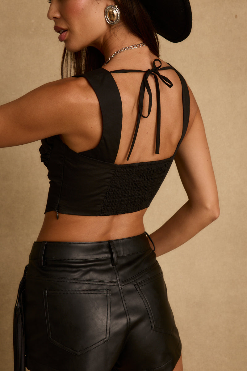 Back view of the black corset top showing the silhouette and fit.