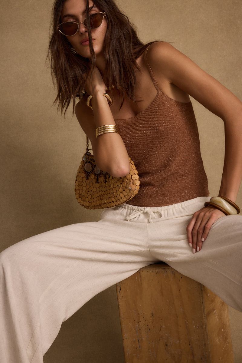Lifestyle shot of the bronze piece styled for day-to-night versatility.