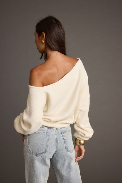 Close-up of the Margot Cream Asymmetrical Sweater showcasing the fabric texture and design details.