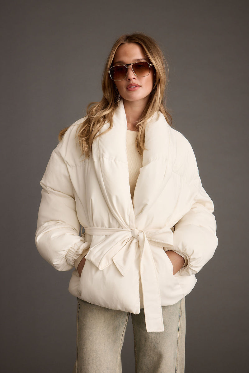 Close-up of the Maverick White Belted Puffer Coat showcasing the fabric texture and design details.