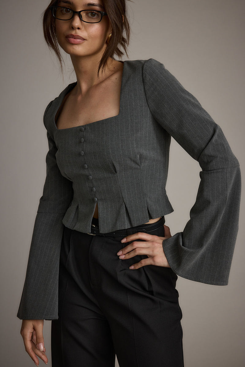 Full-length view of the top showing the drape and movement.