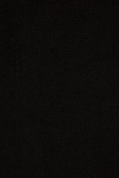 Close-up of black slinky stretch knit fabric used in the Melani midi dress.