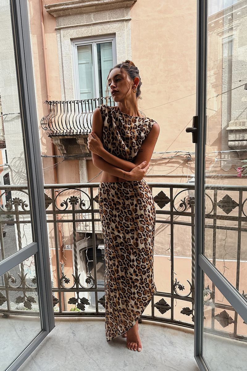 Full-length view of the leopard print maxi skirt showing the drape and movement.