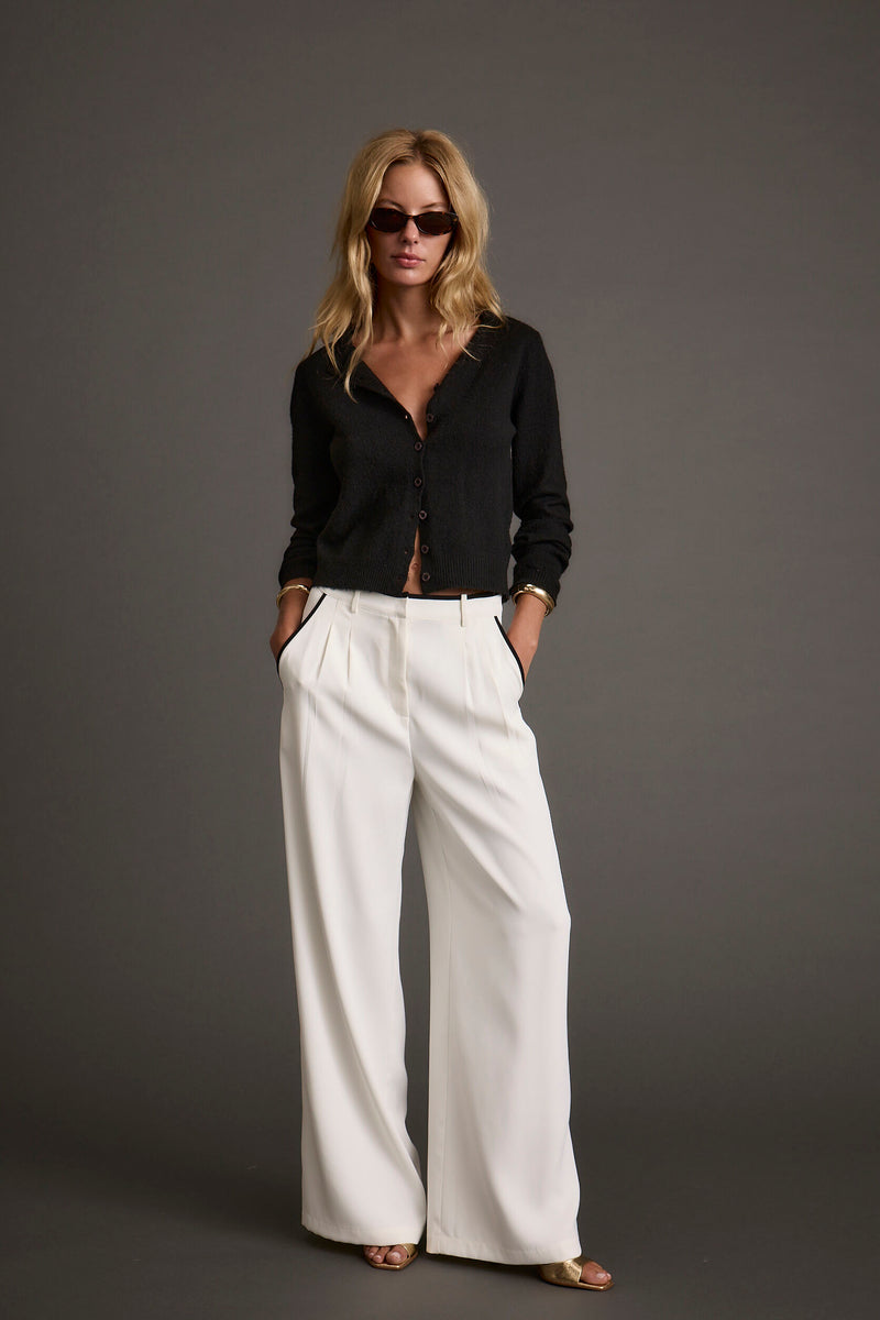 Full-length view of the black cardigan showing the drape and movement.