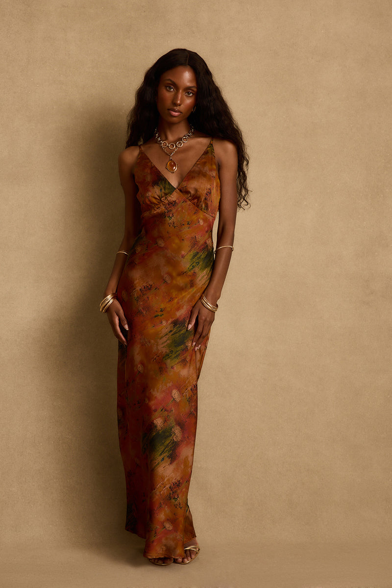 Mirabella rust printed satin maxi dress with v neckline, styled with gold jewelry.