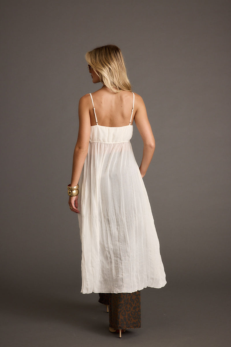 Full-length view of the ivory top showing the drape and movement.
