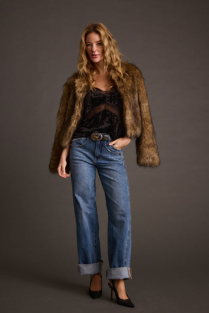 Full-length view of the brown jacket showing the drape and movement.