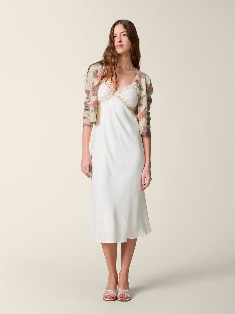 Front view of the white Jenna dress worn with the Albira cardigan.