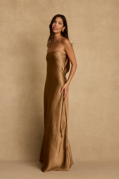 Bronze satin strapless maxi dress shown side-on with a sleek floor-length silhouette.