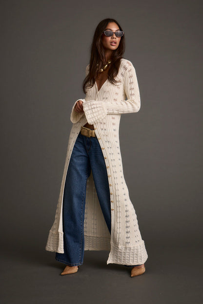 Lifestyle shot of the cream top styled for day-to-night versatility.