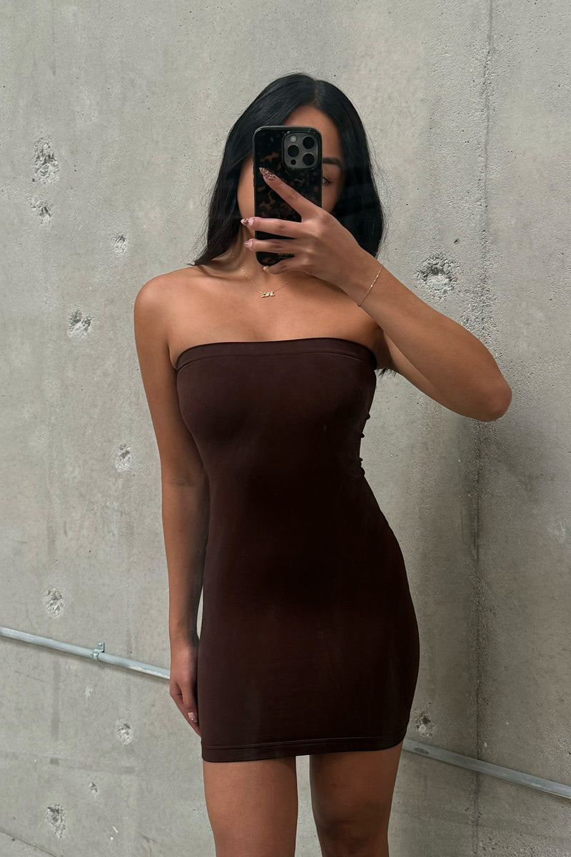 Back view of the brown dress showing the silhouette and fit.