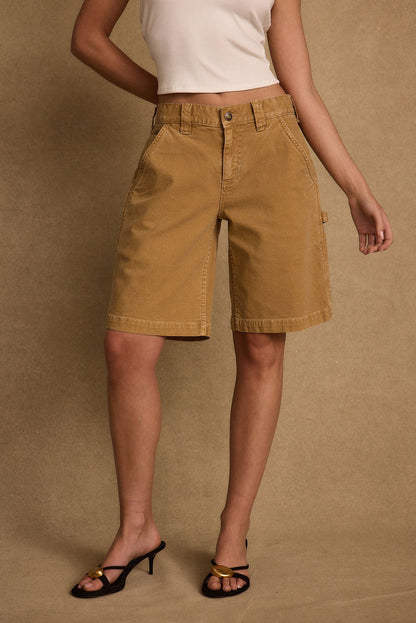 Lifestyle shot of the khaki shorts styled for day-to-night versatility.