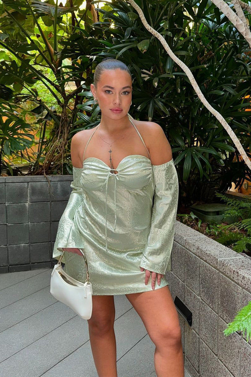 Sage satin mini dress with refined detailing and a flattering silhouette.