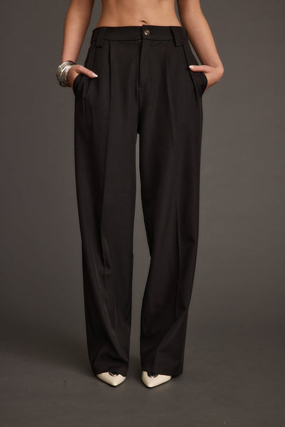 Back view of the black trousers showing the silhouette and fit.