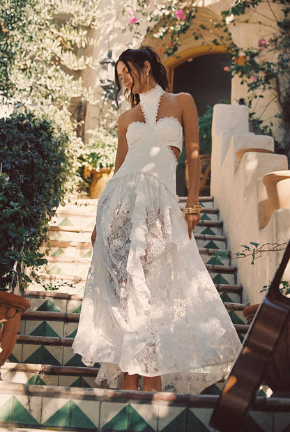 Full-length view of the white maxi dress showing the drape and movement.