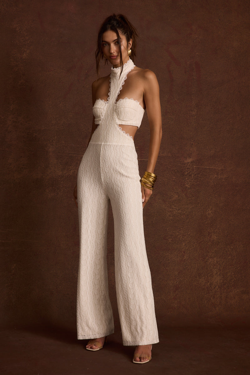 White lace jumpsuit with refined detailing and a flattering silhouette.
