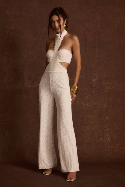 White lace jumpsuit with refined detailing and a flattering silhouette.