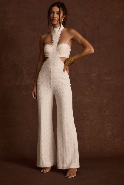 Back view of the white lace jumpsuit showing the silhouette and fit.