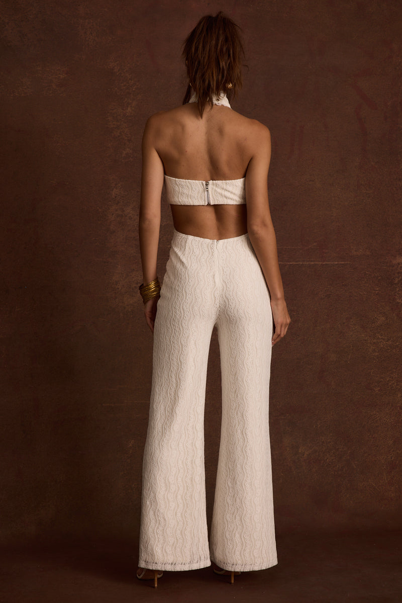 Princesa White Lace Jumpsuit paired with complementary accessories for a polished look.