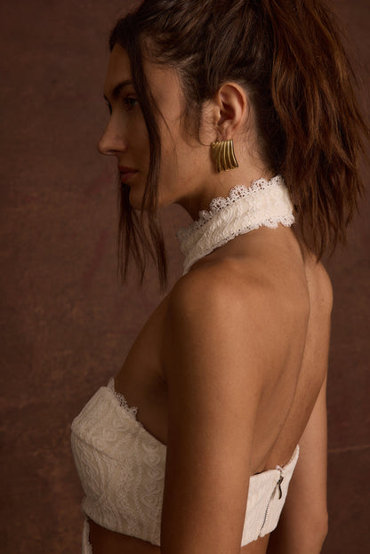 Detail shot of the Princesa White Lace Jumpsuit highlighting the lace elements.