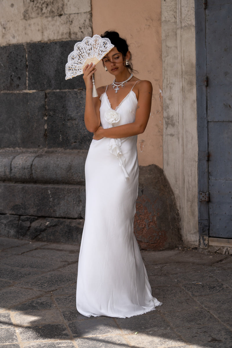 Detail shot of the Prosecco White Rosette Frill Maxi Dress highlighting the design elements.