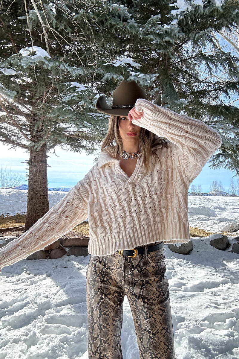 Riverstone Cream Cableknit Sweater styled in a complete look from an alternate angle.