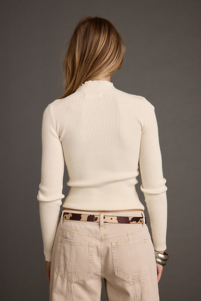 Back view of the white piece showing the silhouette and fit.