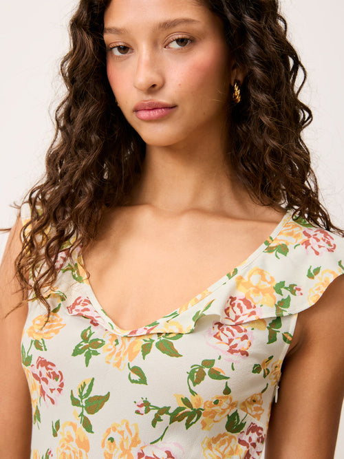 Close-up of the neckline on the Asma sleeveless floral crepe midi dress worn by a model