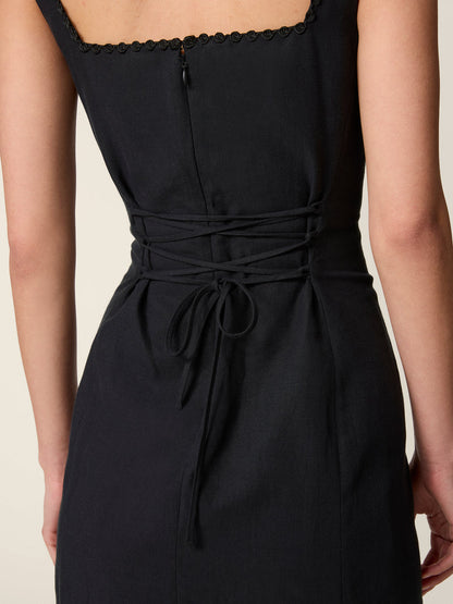 Back view of the black Elny dress tied at the waist.