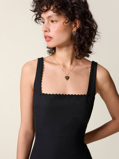 Zoom in on the square neckline of the black Elny dress.