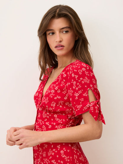 Model wearing the LAURA midi dress by Rouje, slim fit, V-neck, short sleeves with bows, made in Romania