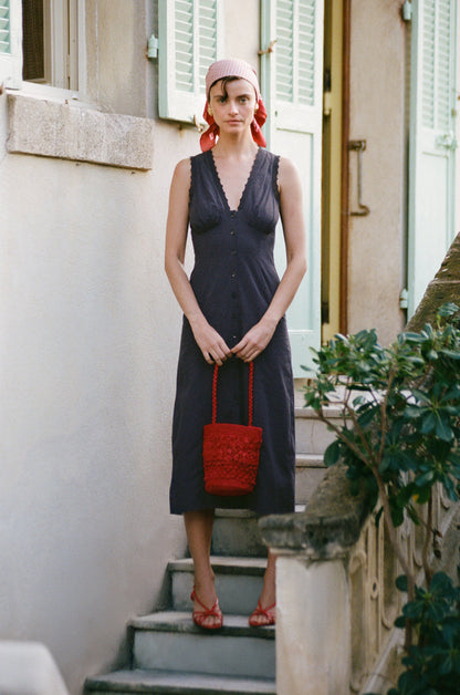 Lifestyle photo of the navy Lisbet dress worn in summer.