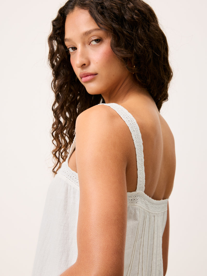 Rachel white short cotton voile strap dress worn by a model, 3/4 back view