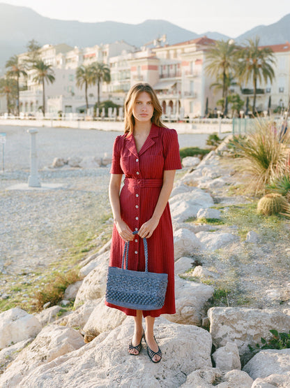RAELLA carmine red seersucker midi dress, lifestyle setting by Rouje