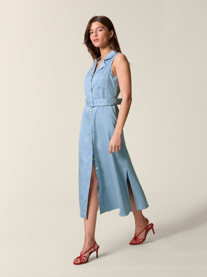 Side view of the blue Raquel dress worn by a moving model.