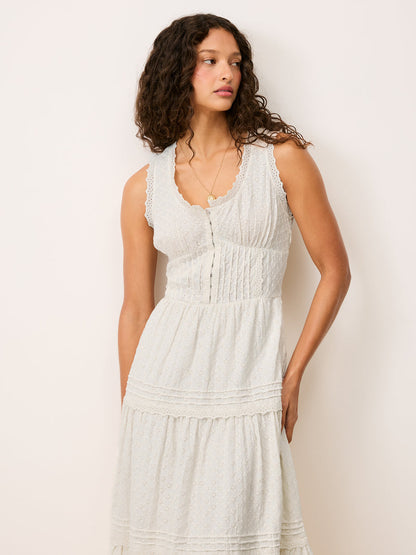 Front view cropped at the waist of the Roselene white maxi dress worn by a model