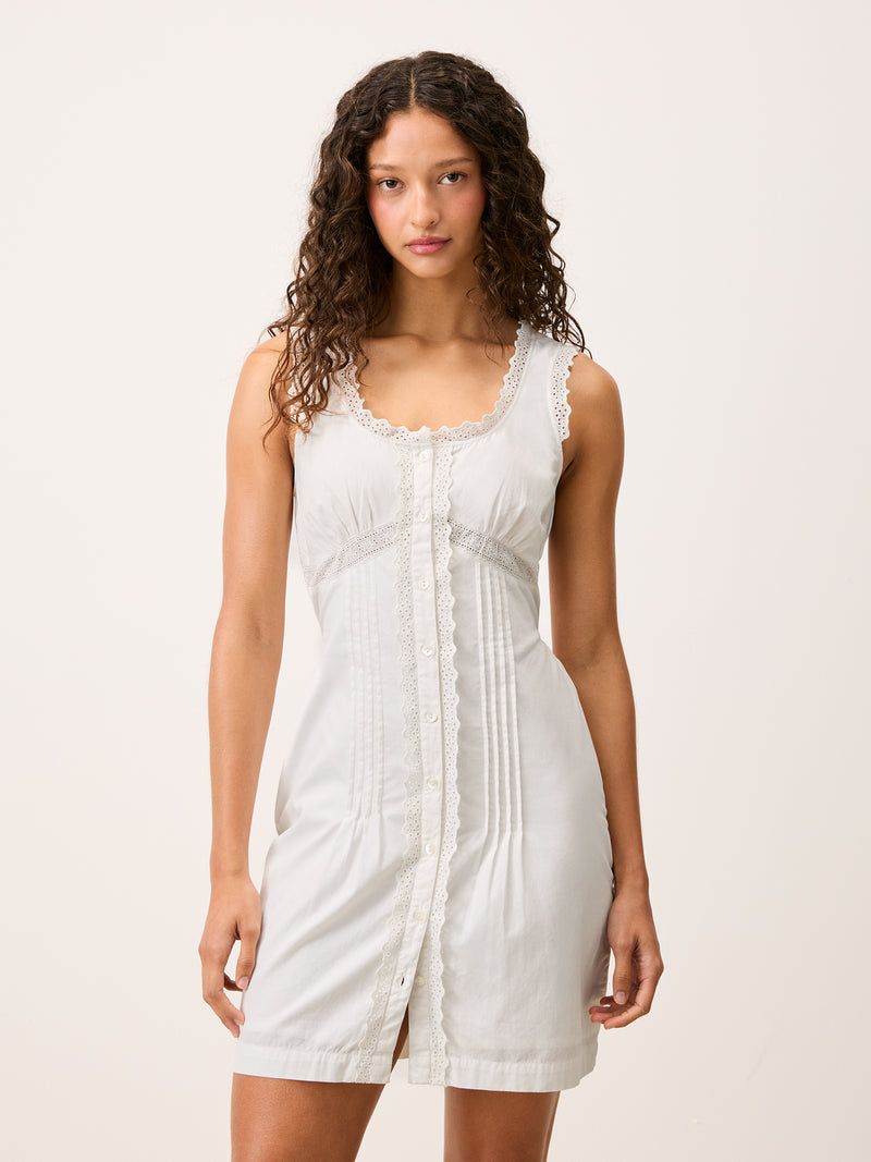 Front view of the Shonie white corset style short dress worn by a model