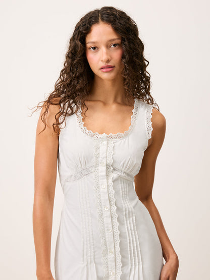 Front view cropped at the waist of the Shonie white corset style short dress worn by a model