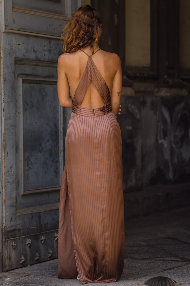 Full-length view of the striped maxi dress showing the drape and movement.