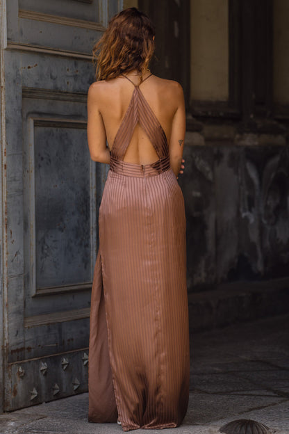 Full-length view of the striped maxi dress showing the drape and movement.