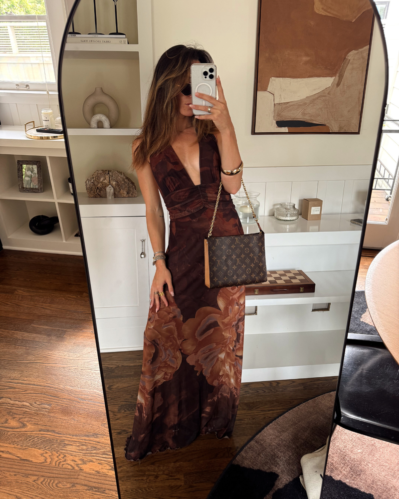 Person modeling a brown floral mesh maxi dress with plunging halter neckline in a mirror selfie.